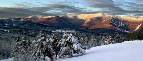 A snow-covered mountain landscape with a clear sky.