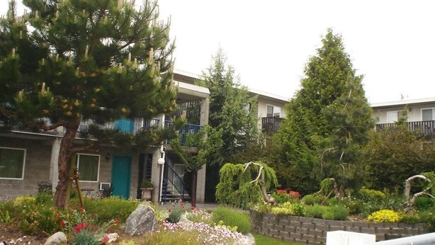 A residential building with a garden in front.