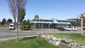 Bayside Motor Inn with a parking lot and a building with a sign for 'Bayside Motor Inn' and 'Bayside Motel - Apartments'.