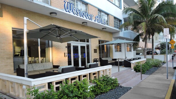 A Westover Arms hotel with outdoor seating and a covered patio area. - Westover Arms Hotel  (Miami Beach)