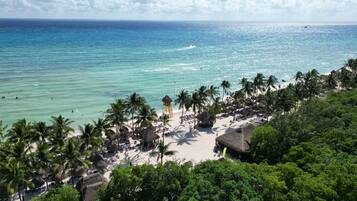On the beach, white sand, sun loungers, beach umbrellas