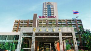 A hotel with a prominent sign reading "KOSA" and a Thai flag.