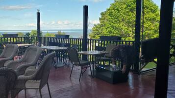 Relax on the deck with a view of the sea and surrounding trees.