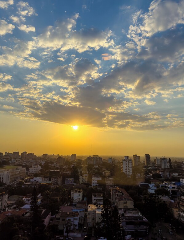 A cityscape with buildings and a sunset.