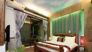 A bedroom with a bed, curtains, a sliding glass door, and a green wall. - Beautiful Ilan Resort (Dongshan)