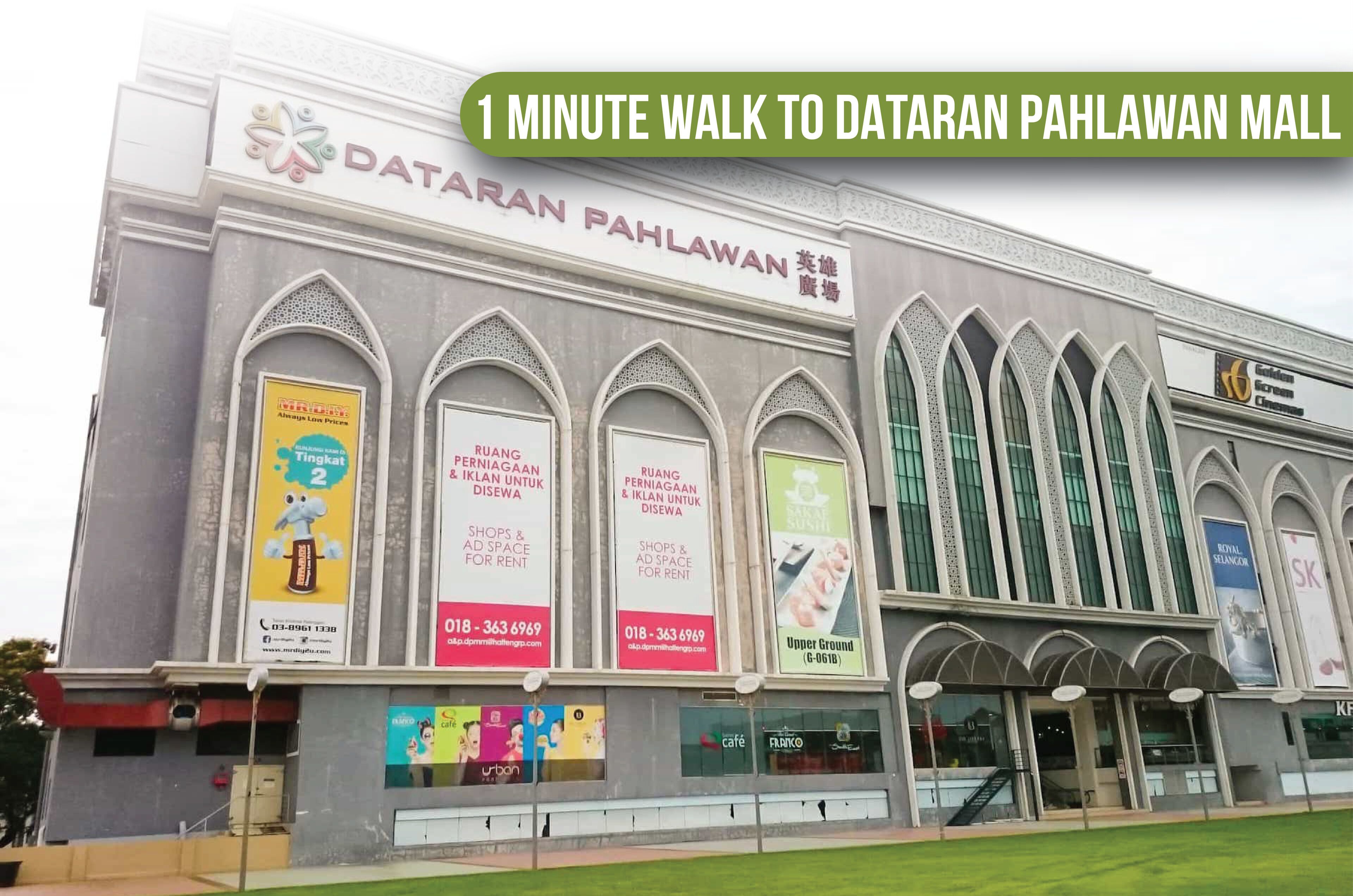 A building with the sign 'Dataran Pahlawan Mall' and multiple advertisements for shops and services.