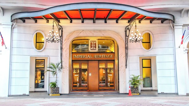Exterior del hotel Imperial Heritage con una entrada imponente, grandes ventanales y dos plantas en macetas.