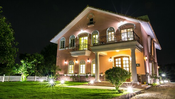A two-story house with a balcony, large windows, and a well-lit front porch. - Belle Garden Yillan Villa (Dongshan)