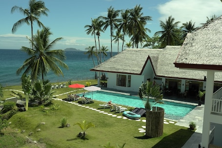 Outdoor pool, pool umbrellas, pool loungers. Sea Dream Resorts