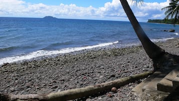 On the beach, black sand, beach towels, scuba diving