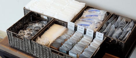 A display of various toiletries in wicker baskets on a table.