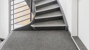 A modern spiral staircase with metal railings and carpeted steps, leading to a door marked "C2A3". - VISIONAPARTMENTS Zurich Cramerstrasse 2-6 (Zürich)