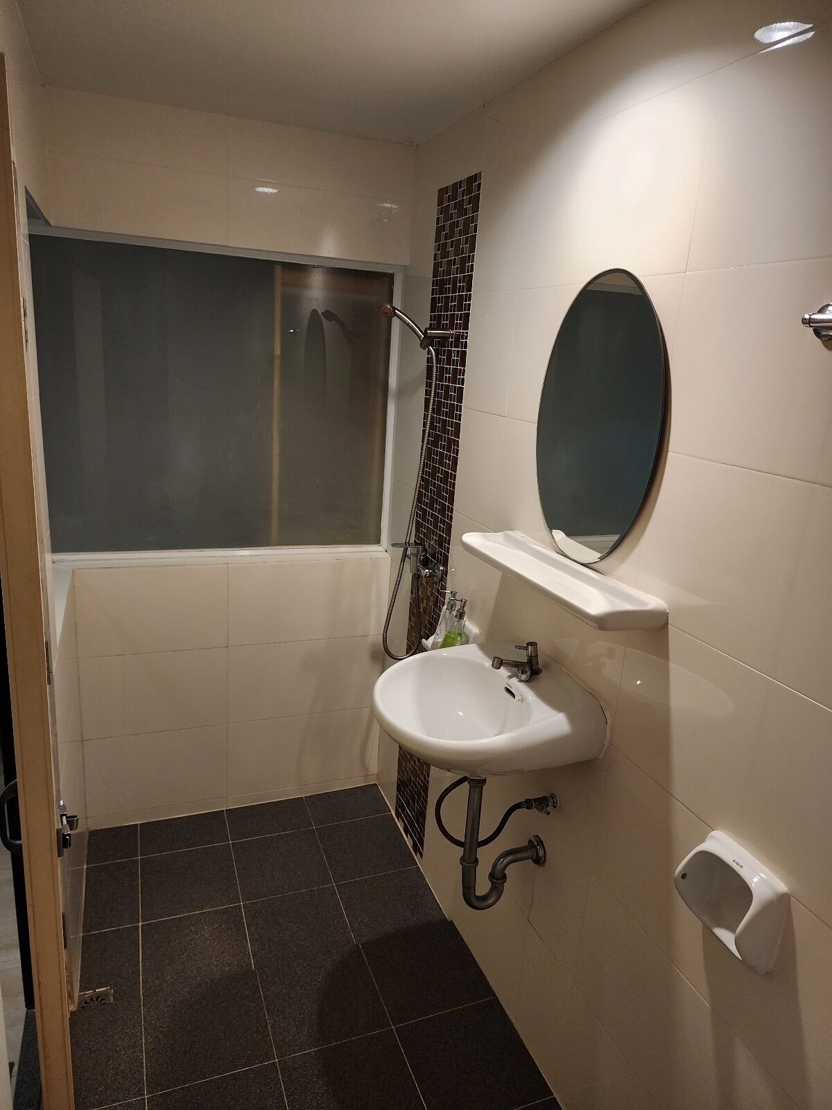 A bathroom with a bathtub, a sink, a mirror, and a shower.