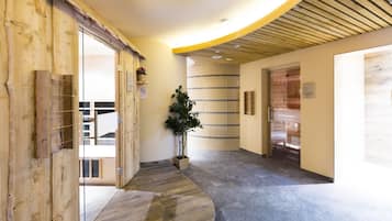 Welcome to our hotel lobby, featuring a curved reception desk, a potted plant, and a unique striped pattern on the walls.