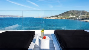 A balcony with a clear view of the sea and a distant hill. - Captain Zeppos (Milos)