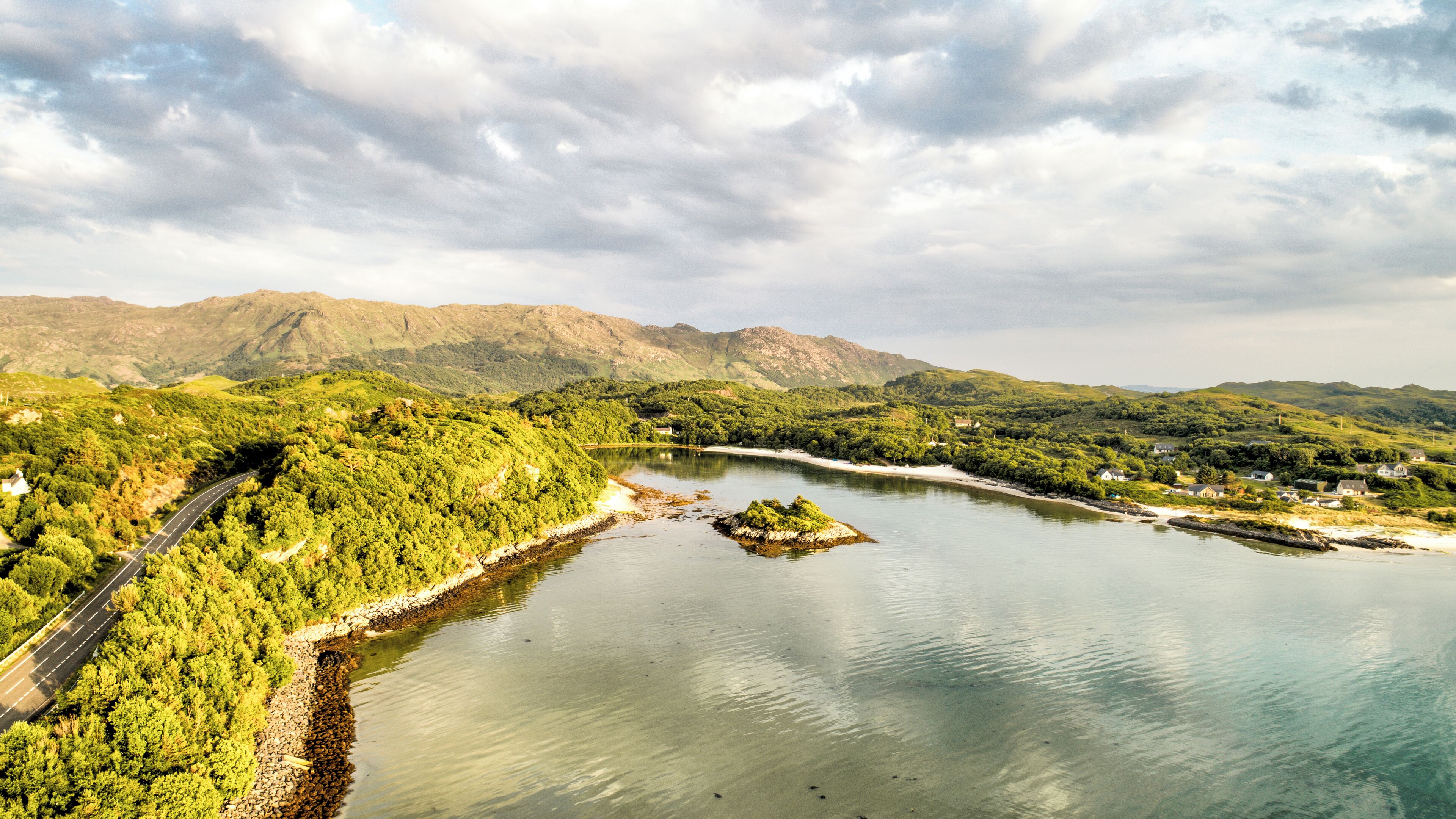 A scenic landscape with a river, a road, and a small island.