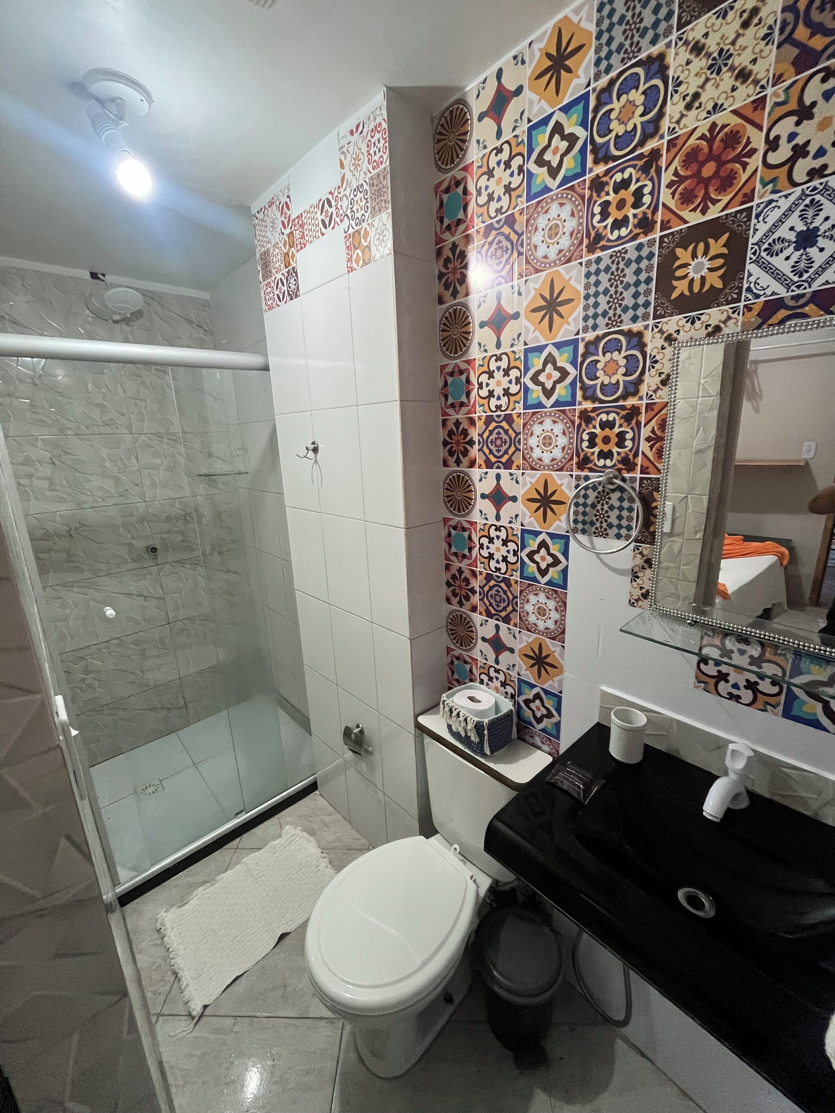 A bathroom with a shower, toilet, and sink.