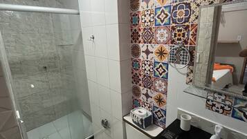 A bathroom with a shower, toilet, and sink.