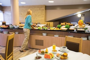 Enjoy a delicious buffet breakfast in our dining area, featuring a variety of fresh fruits, vegetables, and prepared dishes.