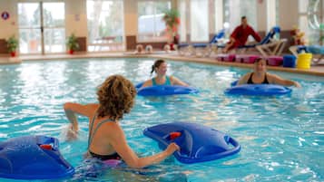 Swimmers can enjoy a refreshing dip in the pool surrounded by lounge chairs.