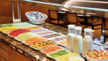 A buffet with various food items and beverages.