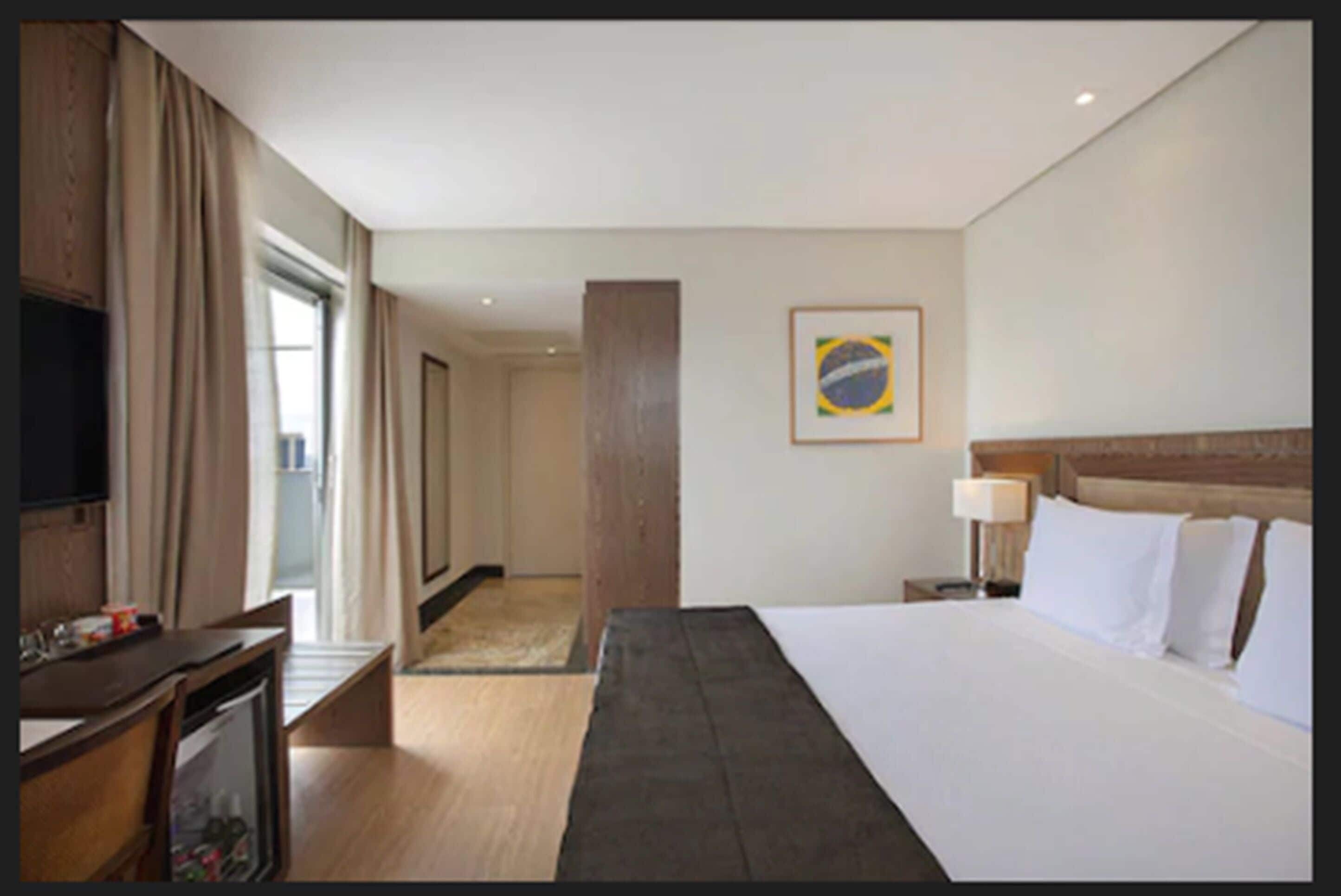 deluxe room, balcony | minibar, in-room safe, desk, laptop workspace