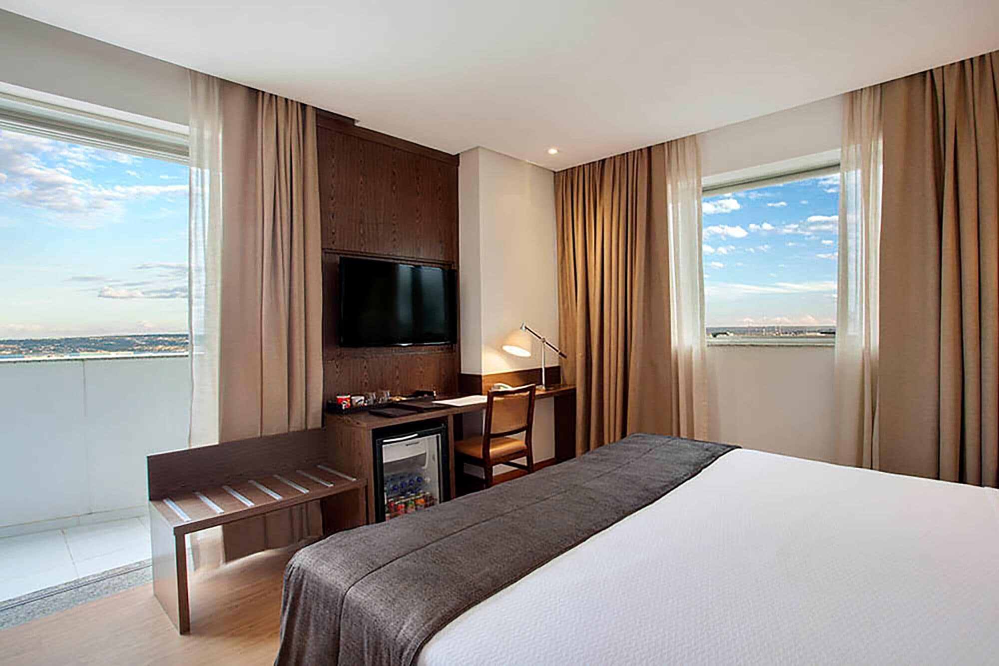 deluxe room, balcony | minibar, in-room safe, desk, laptop workspace