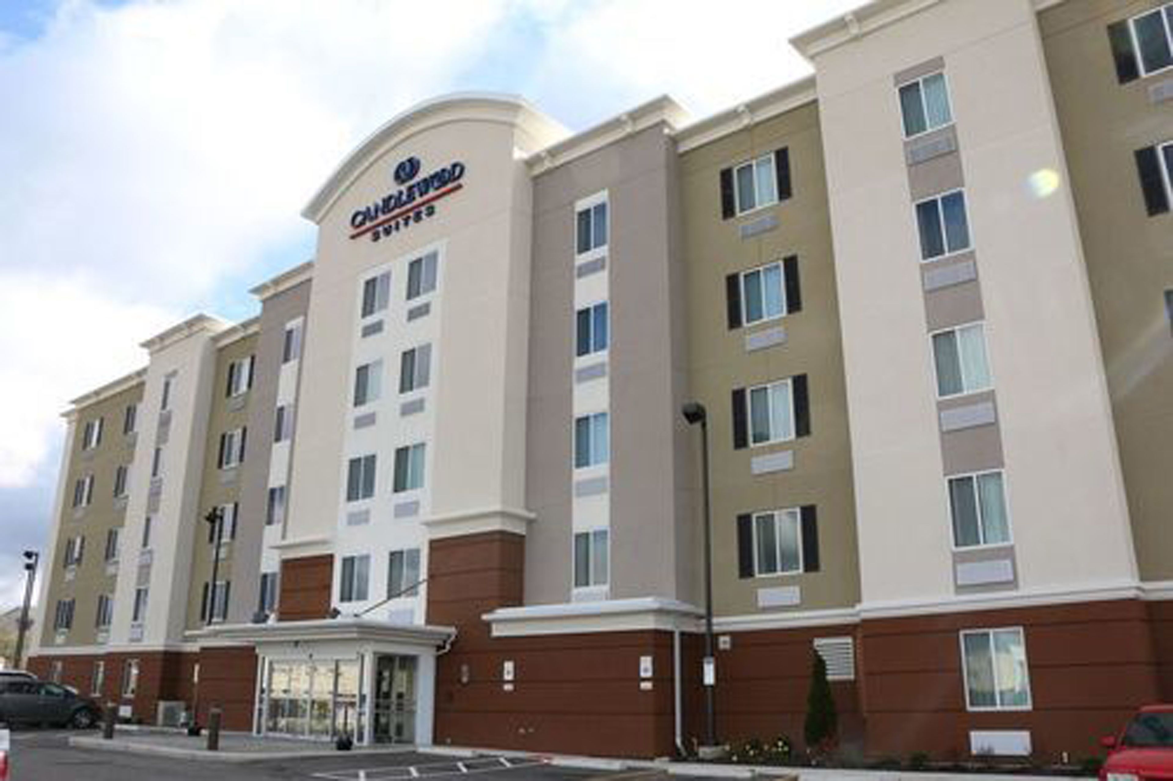 A multi-story hotel with a prominent sign at the entrance.