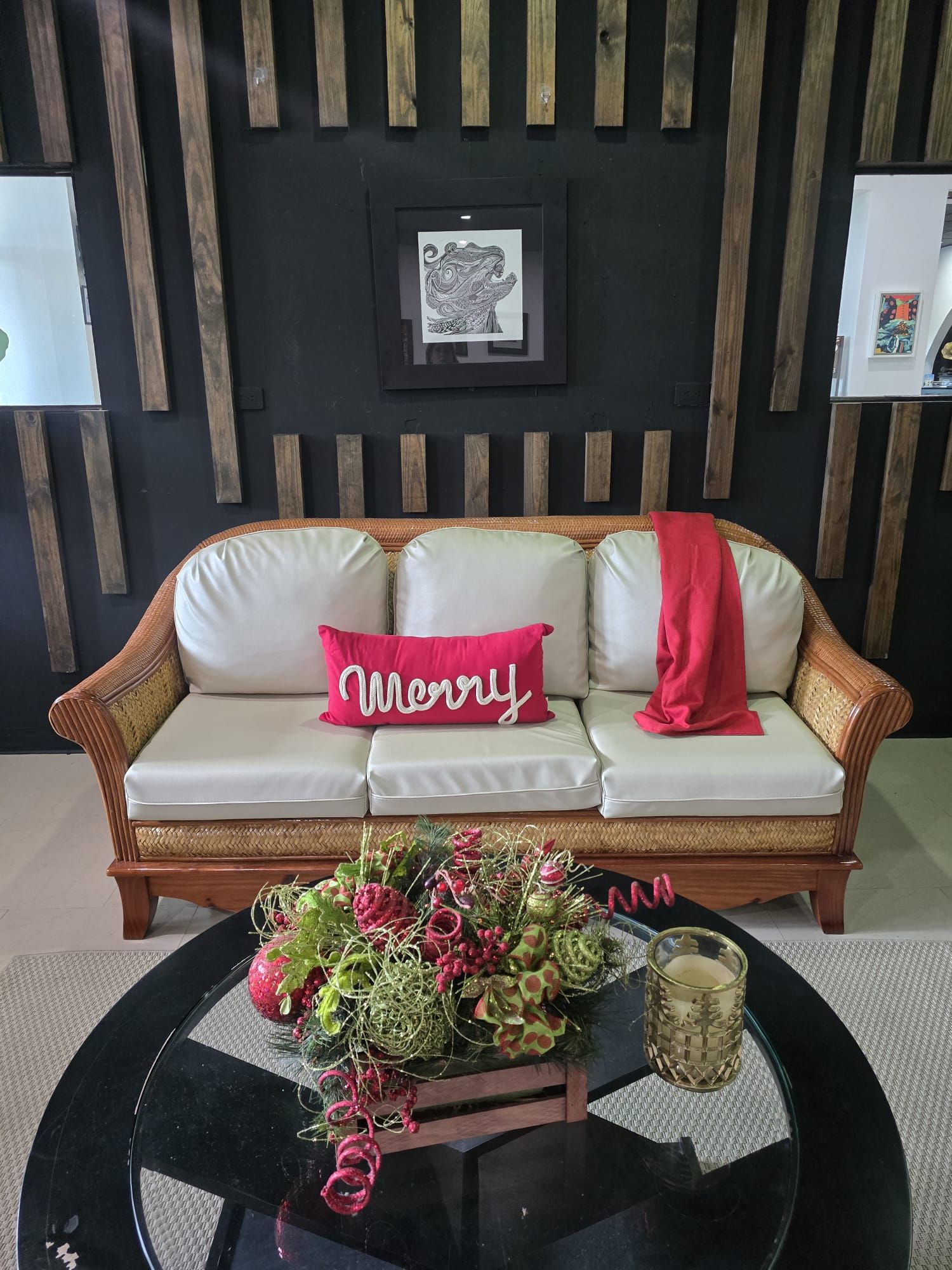A modern living room with a sofa, a coffee table, and a wall with vertical wooden slats.