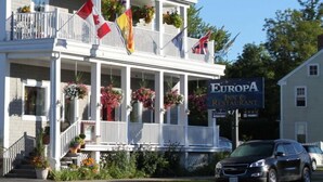 A two-story building with a balcony, flags, and a sign for Europa Inn & Restaurant. - Europa Inn (St. Andrews)
