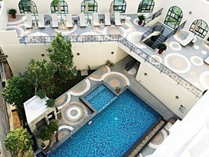 Alberca al aire libre y camastros 