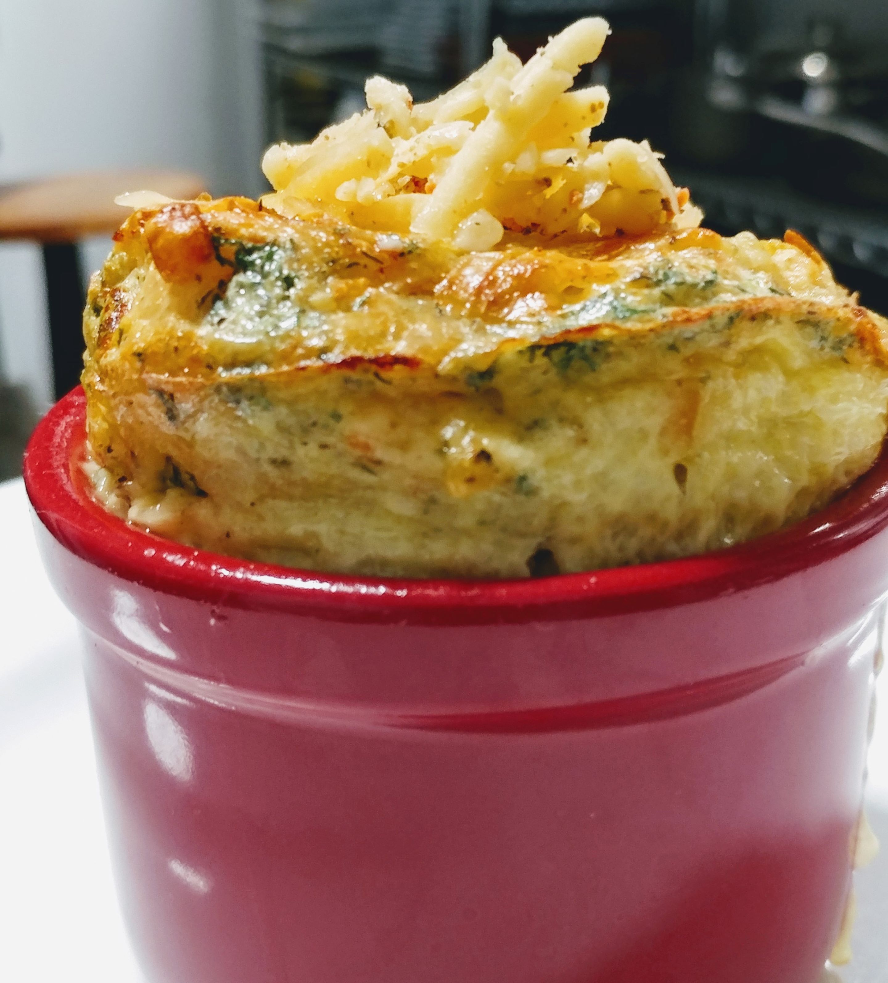 A close-up of a baked dish in a red bowl.