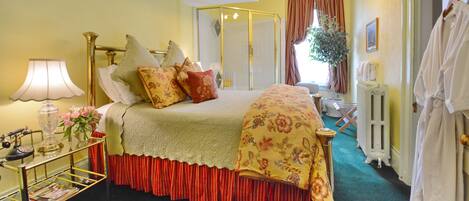 A bedroom with a bed, bedside table, lamp, and a radiator.