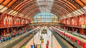 A spacious train station with a high, arched roof and multiple tracks. - Hotel Paulistano (São Paulo)