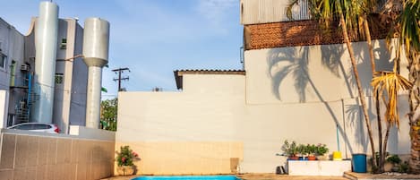 Una piscina al aire libre, sillones reclinables de piscina