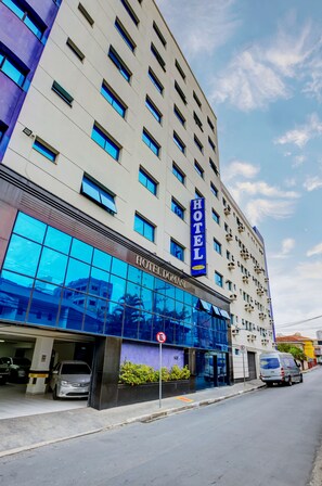 A hotel building with a modern facade, large windows, and a prominent 'HOTEL' sign. - Hotel Domani (Guarulhos)