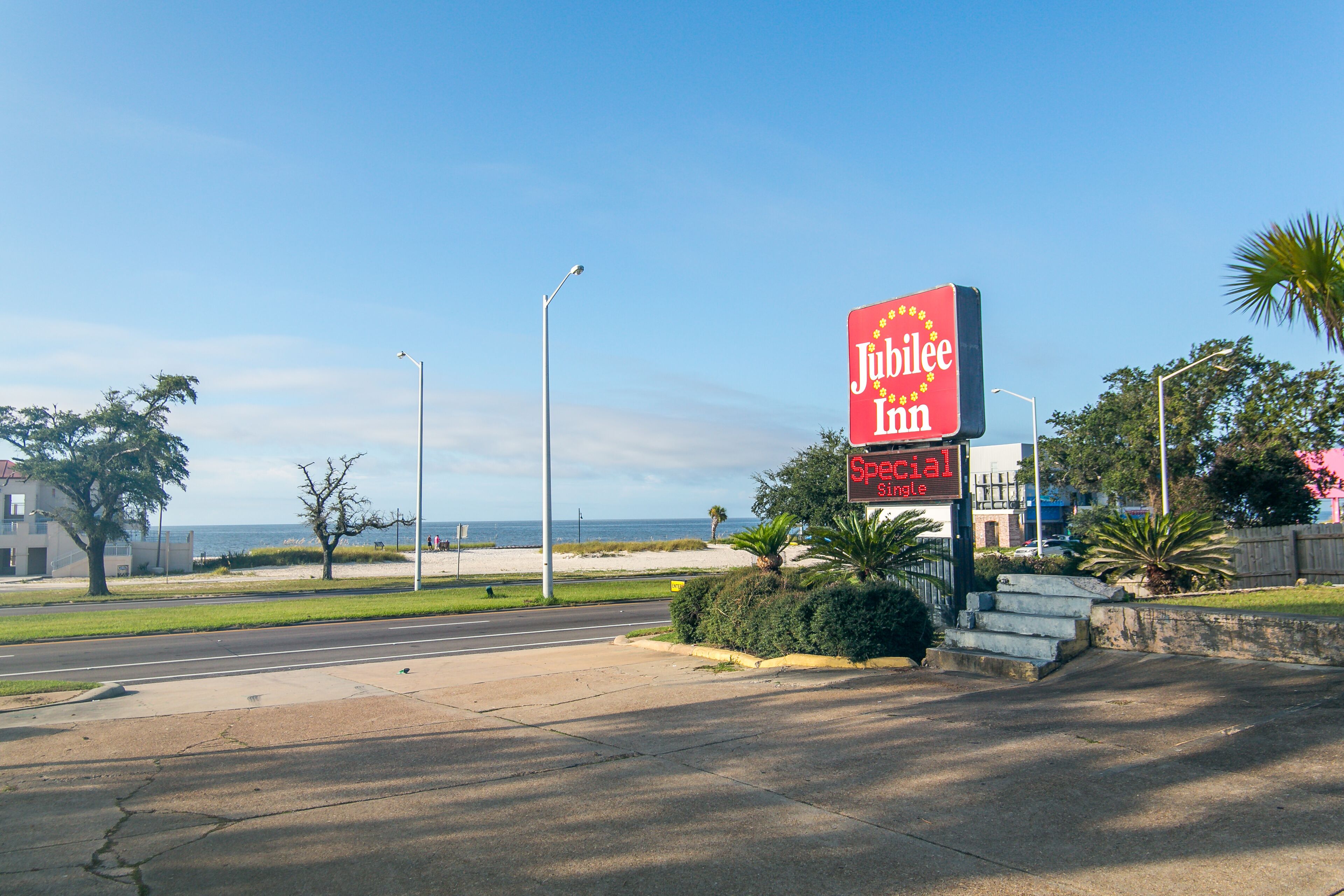 A Jubilee Inn sign with a beach view.