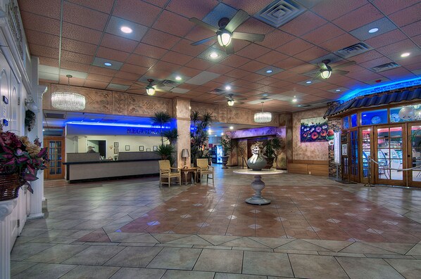 A spacious lobby with a reception desk, seating area, and a decorative fountain. - Shalimar Hotel of Las Vegas (Las Vegas)