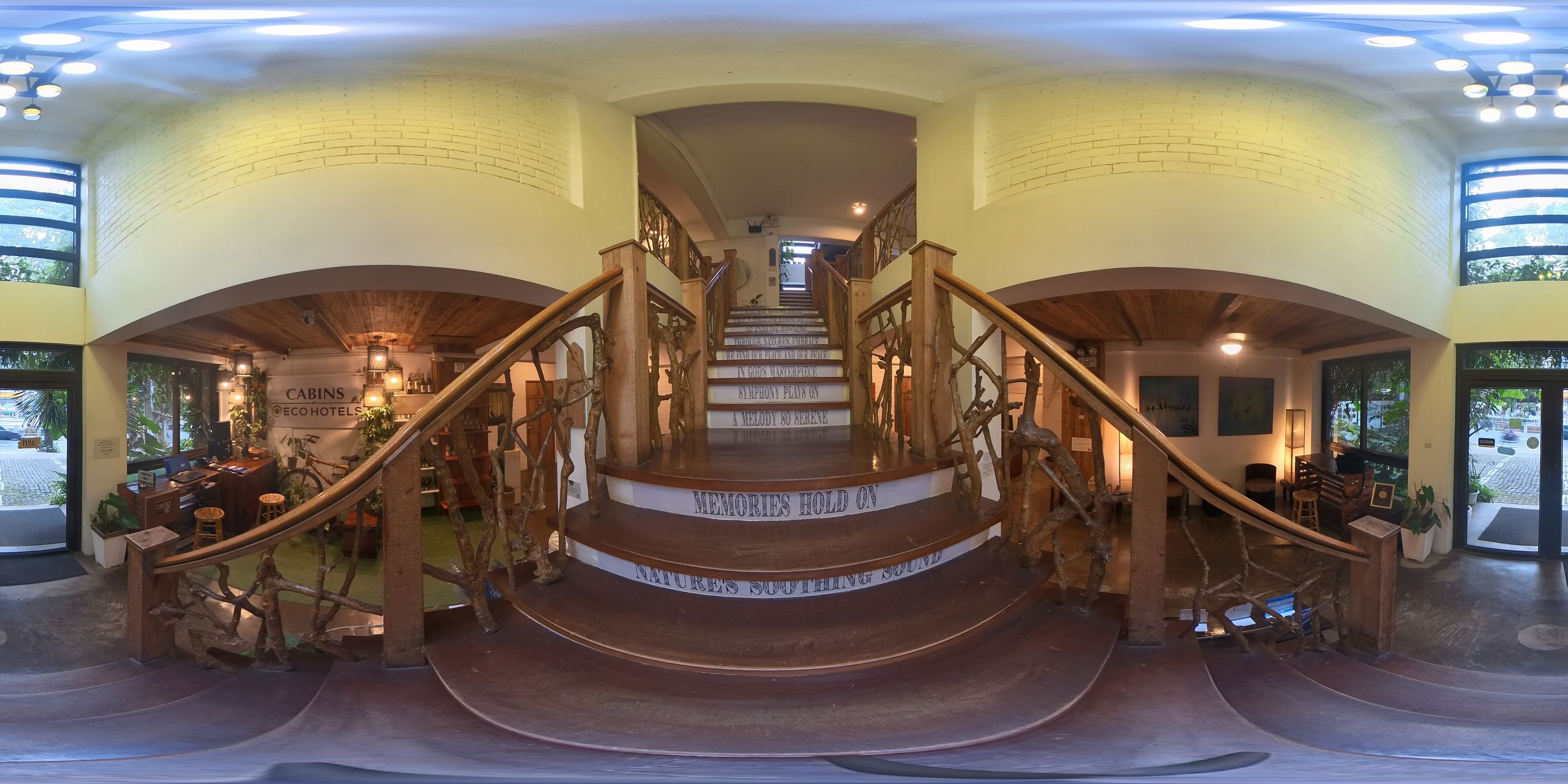 A grand staircase with wooden railings and a sign reading "Memories Hold On."