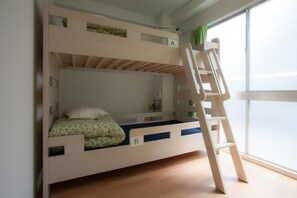 A bunk bed with two levels, each with a lettered compartment. A ladder is attached to the side of the upper bunk. - Nagoya Travellers Hostel (Nagoya)