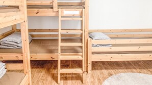 A bunk bed with a ladder, wooden flooring, and a white wall. - Empathy Guesthouse - Hostel (Daegu)