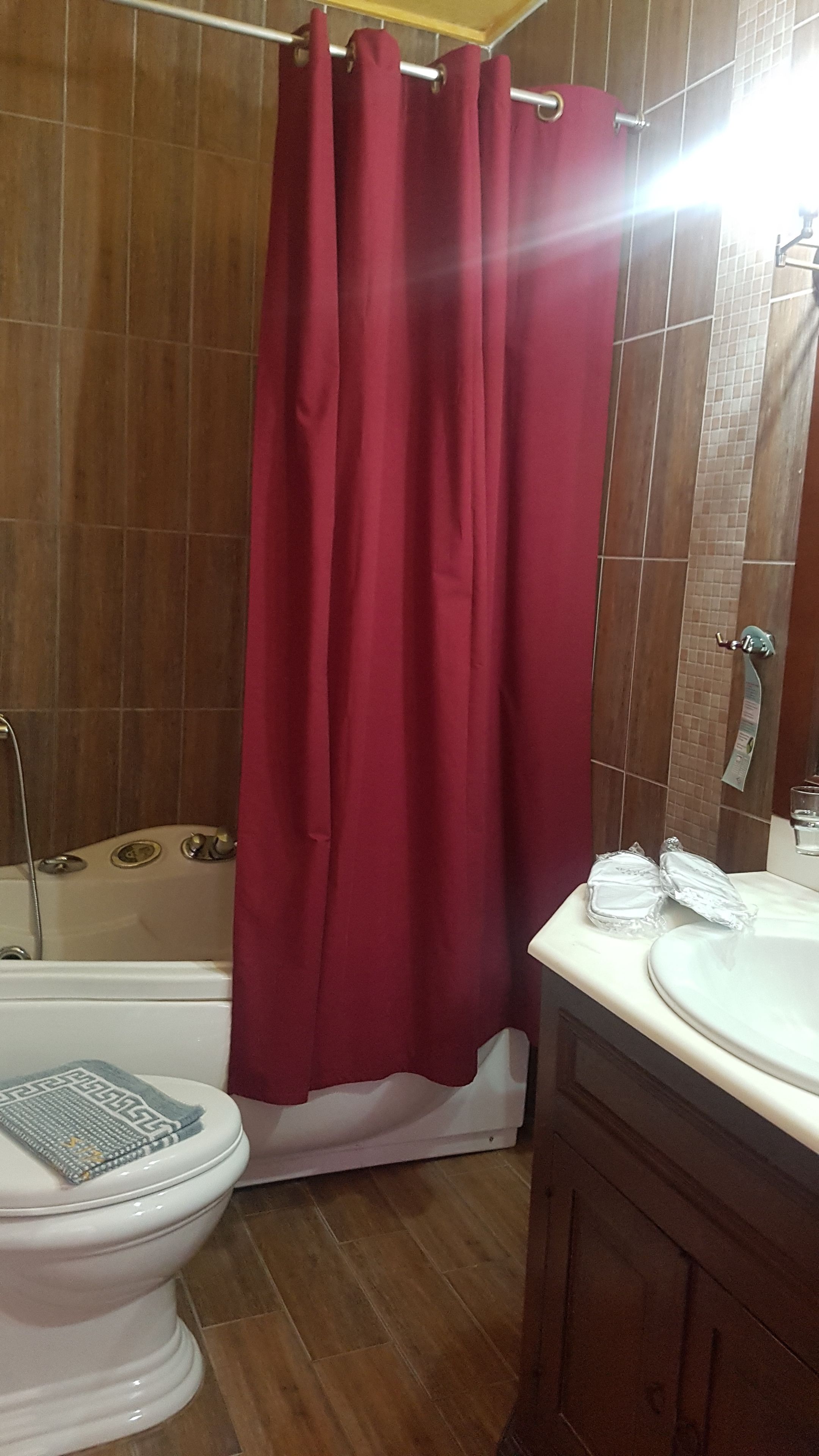 A bathroom with a bathtub, toilet, and sink.