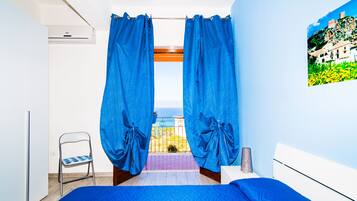 Habitación triple, balcón, vistas al mar | Ropa de cama de alta calidad y edredones de plumas