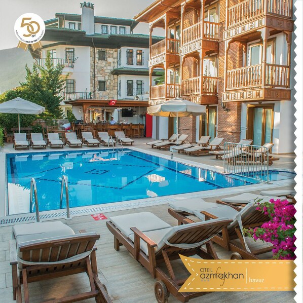 Seasonal outdoor pool, a waterfall pool, pool loungers