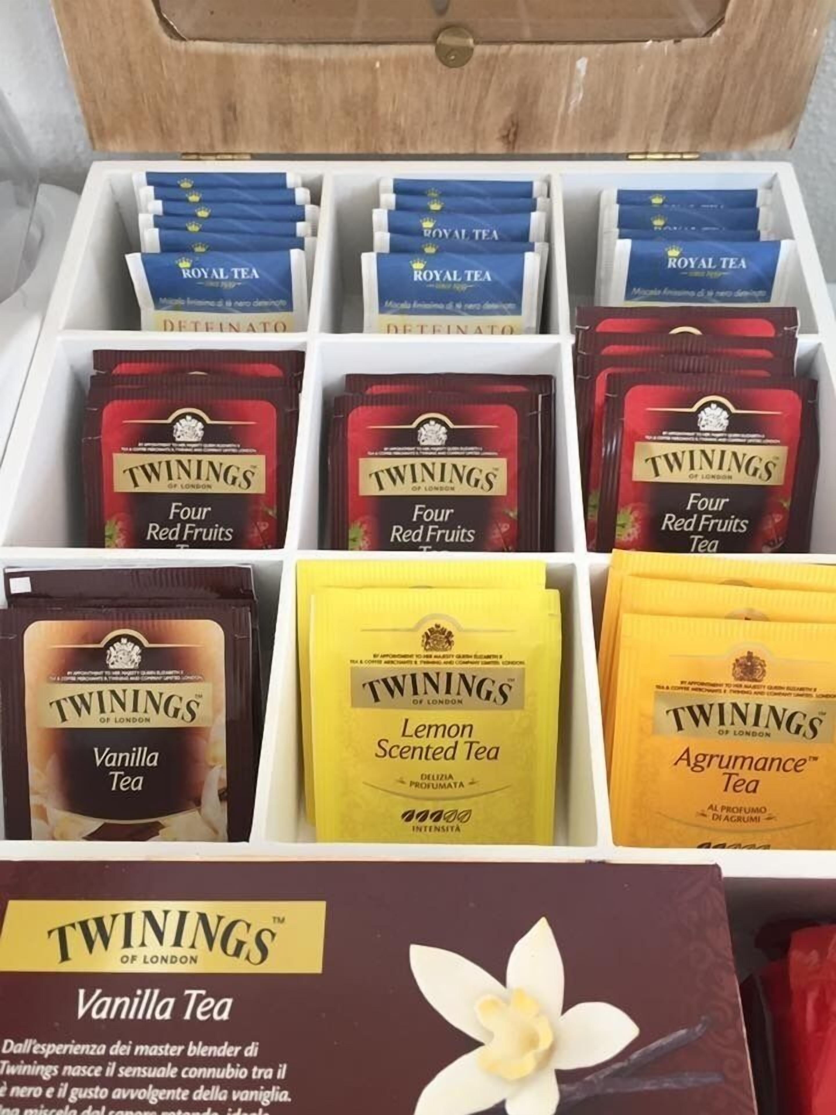 A box of Twinings tea varieties including Four Red Fruits Tea, Vanilla Tea, Lemon Scented Tea, and Agrumance Tea.