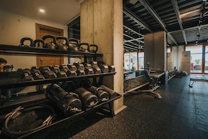 A gym with kettlebells, dumbbells, and weight plates. - Hotel Lotus Spa&Sport Akyaka (Ula)