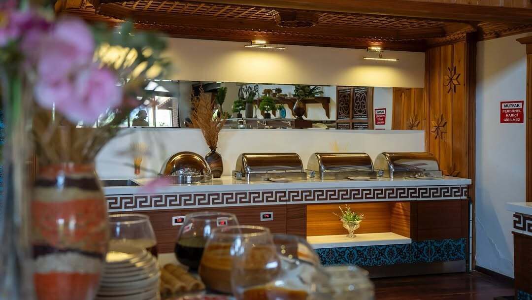 A buffet area with a decorative border, a mirror, and a sign indicating a smoking area.