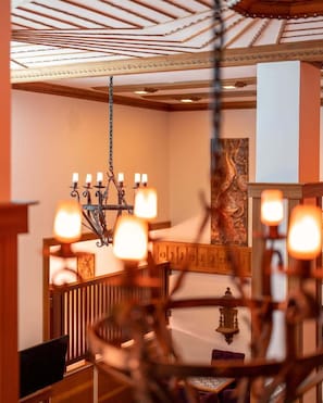 A room with a wooden ceiling, a chandelier, and a painting on the wall. - Hotel Lotus Spa&Sport Akyaka (Ula)