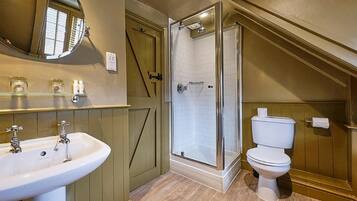 A bathroom with a sink, toilet, and shower.