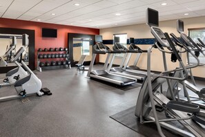 A gym with treadmills, elliptical machines, and dumbbells. - Hampton Inn & Suites Corpus Christi (Corpus Christi)
